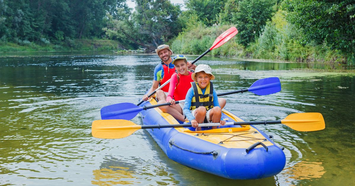 A family smiling in an Inflatable Kayak