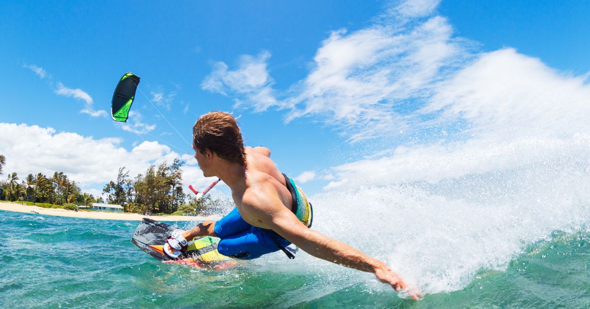 Person touching the water while kiteboarding