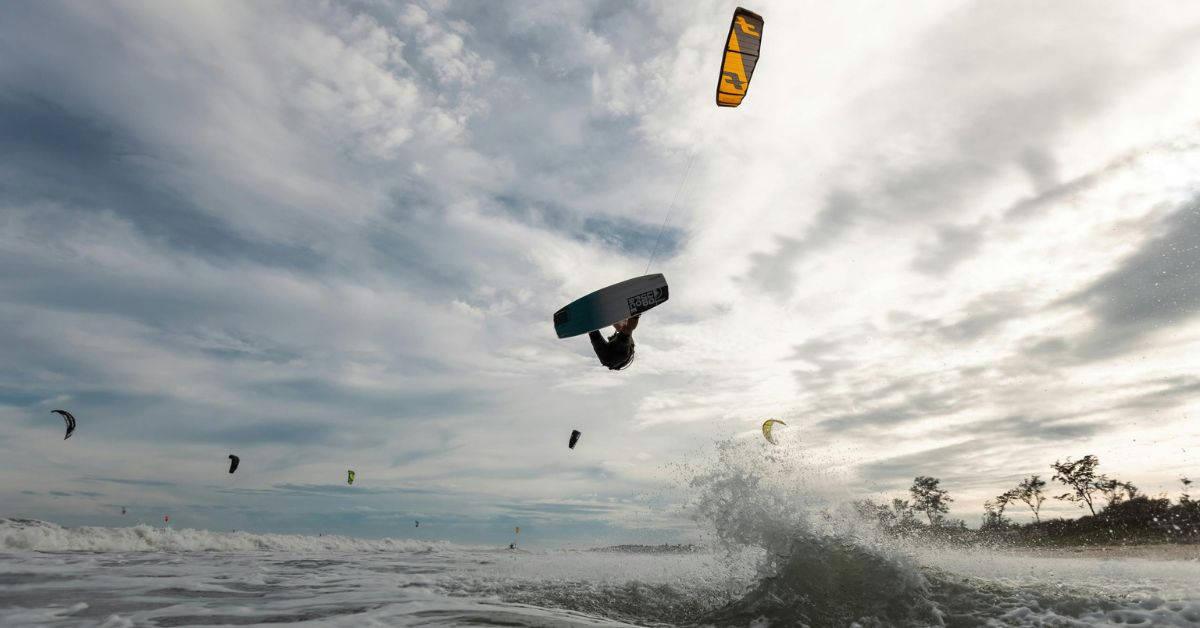 Person jumping in the are while kiteboarding