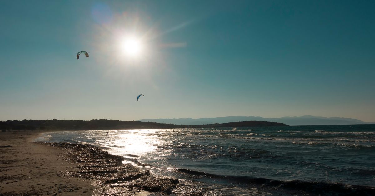 Sunny day with some kites flying over the ocean