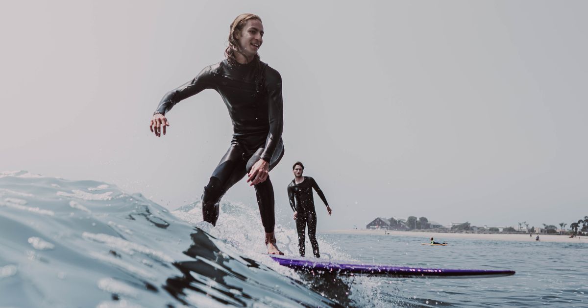 Two guys surfing