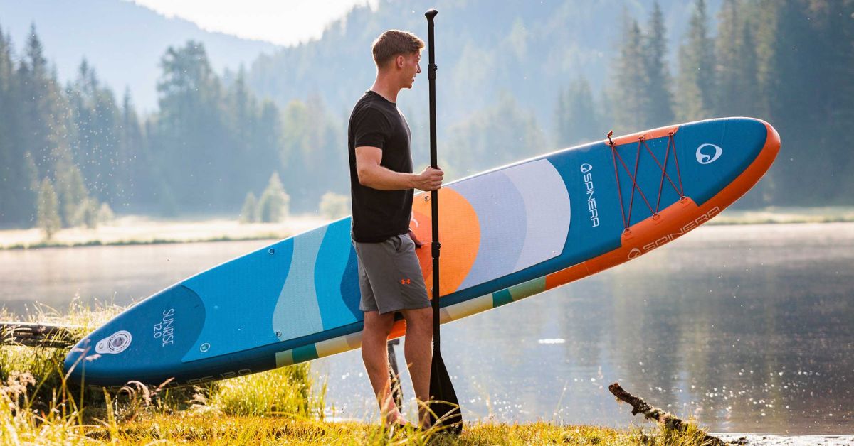Man holding a paddle board
