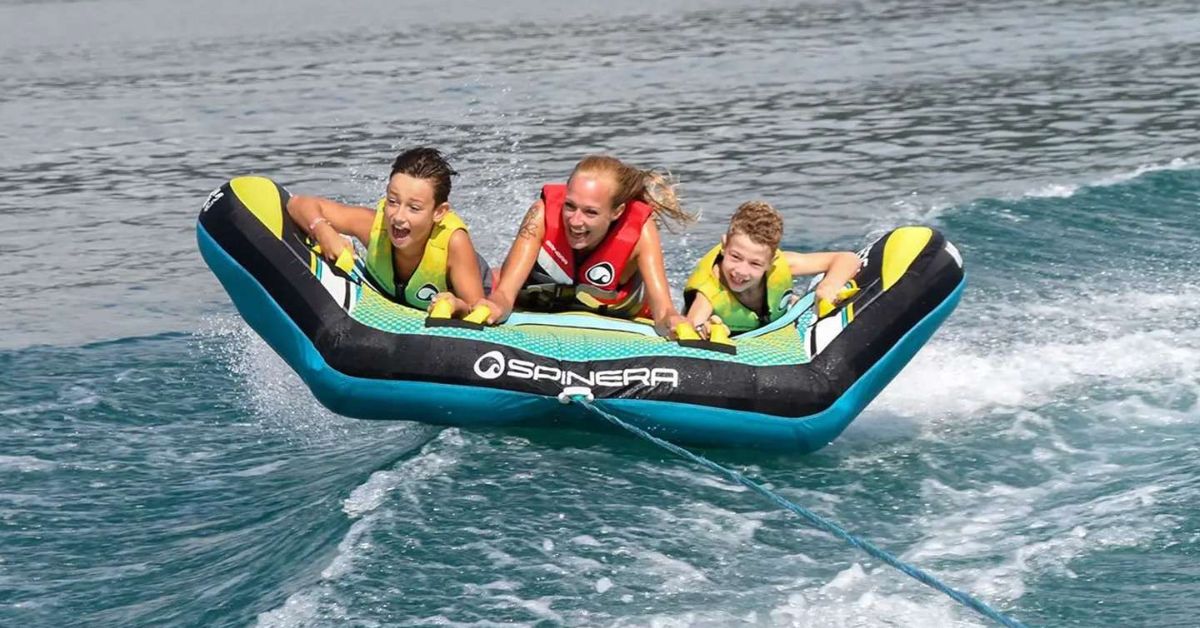 Boat Tube being towed on the water with a family in it.